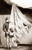 Soldier with a tattered flag circa 1864