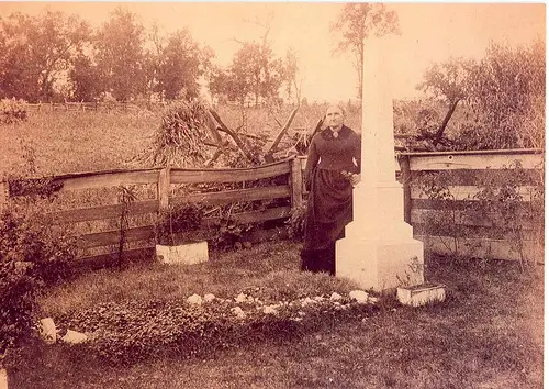 Jesse James' mother, Zerelda, standing next to his grave on the family farm